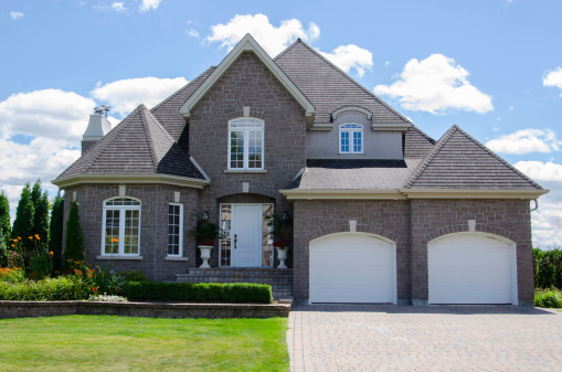 A large brick house with two garage doors.