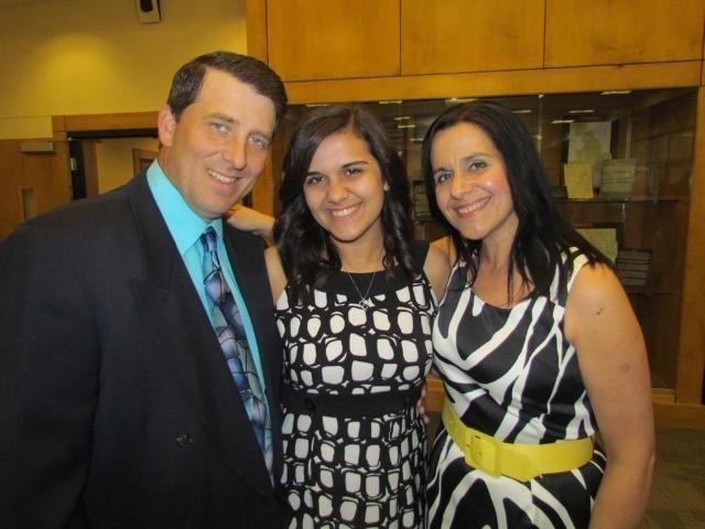 A man and two women posing for the camera.