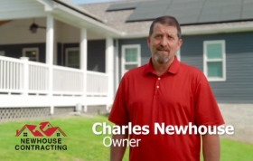 A man standing in front of a house.